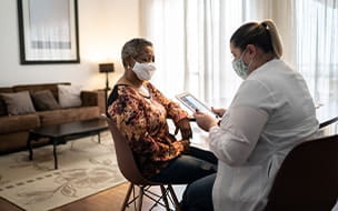 Doctor talking to senior woman patient