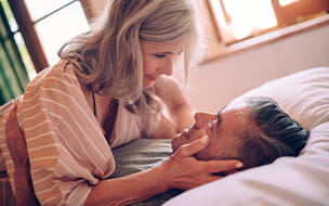 Mature couple flirting in bed
