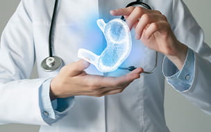 Gastroenterologist doctor with highlighted illustration of human stomach