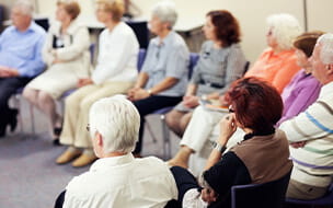 Seniors in the community center listening to the seminar.