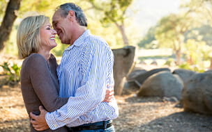 Happy mature couple hugging in the park