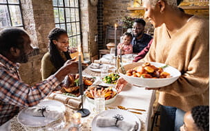 Family gathered around a dining table enjoying holiday meal