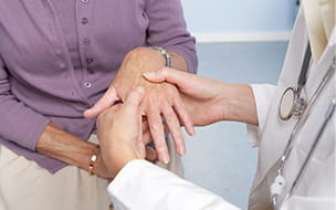 Doctor accessing an arthritic hand.