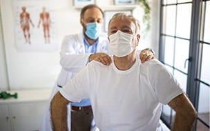 Senior man with back injury in physiotherapist office