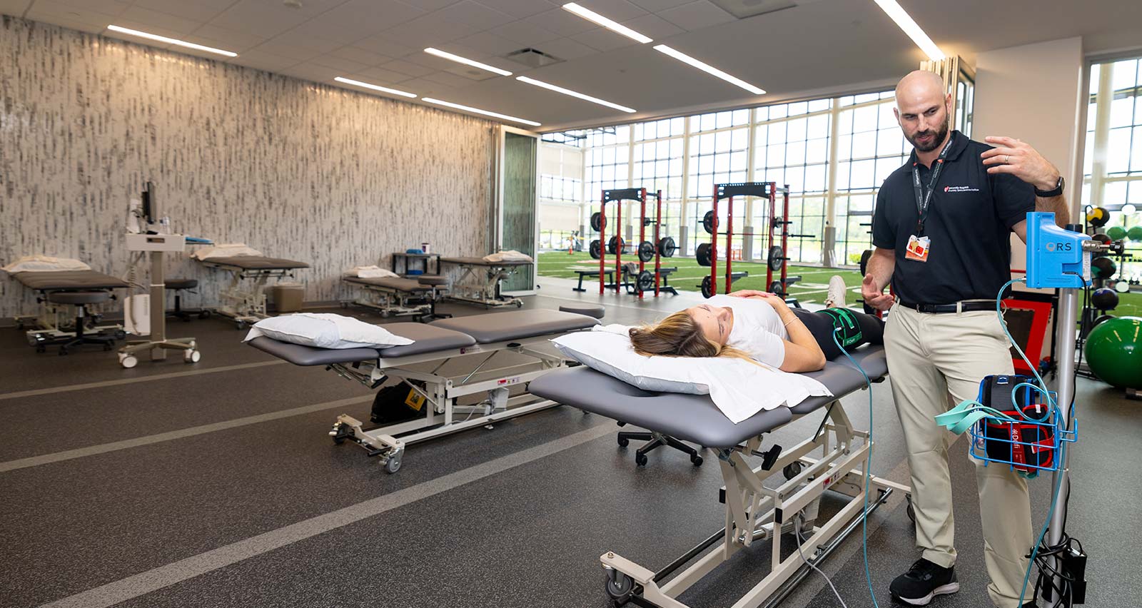 Brad Brigagliano PT, DPT, OCS, MTC, CSCS assists a patient