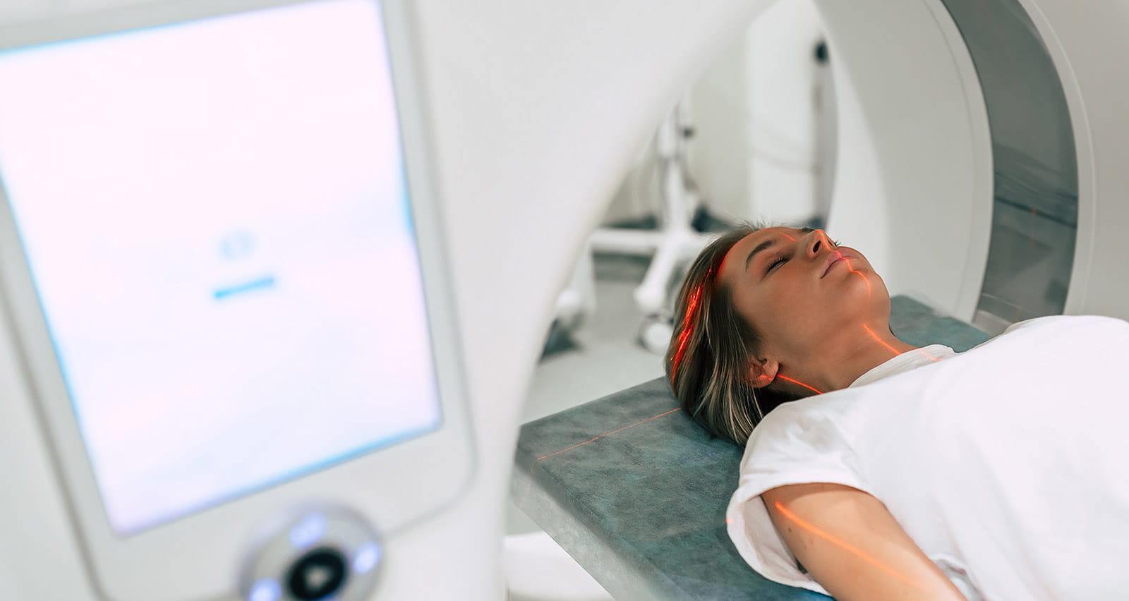 A young female patient enters Magnetic Resonance Imaging for a brain scan