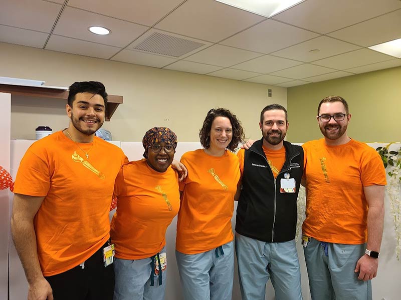 group of residents in orange shirts