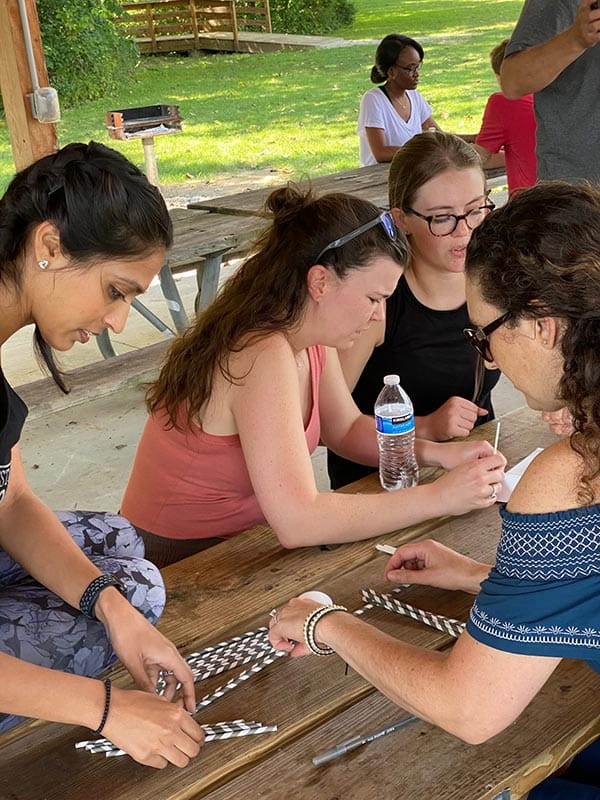 residents at table building project at wellness retreat