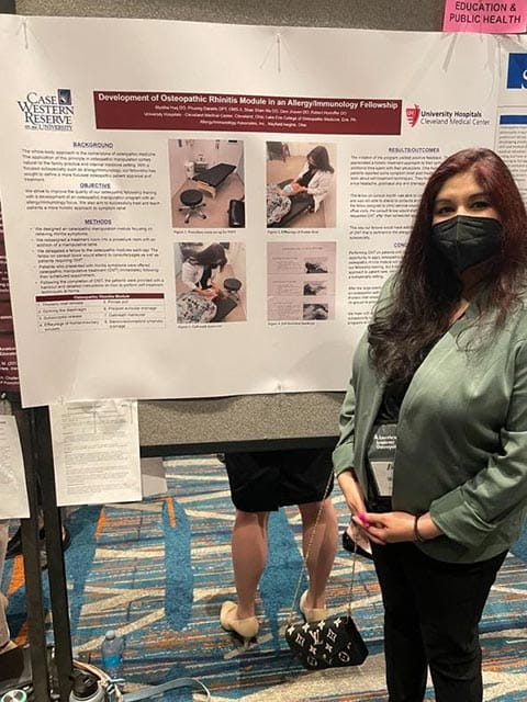 osteopathic student with research poster