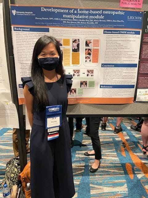 osteopathic student with research poster