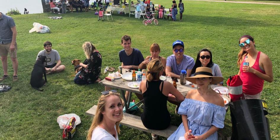 Residents sitting on lawn with picnic