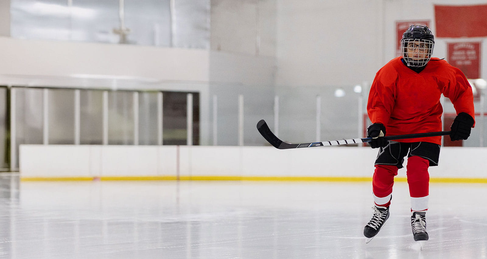 A young boy playing ice hockey