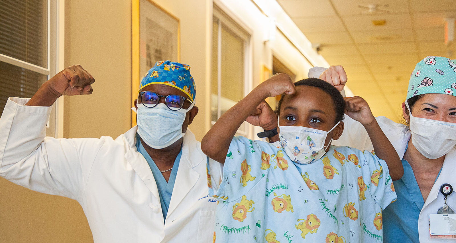 Drs. Barksdale and Woo and a young patient celebrate patient strength