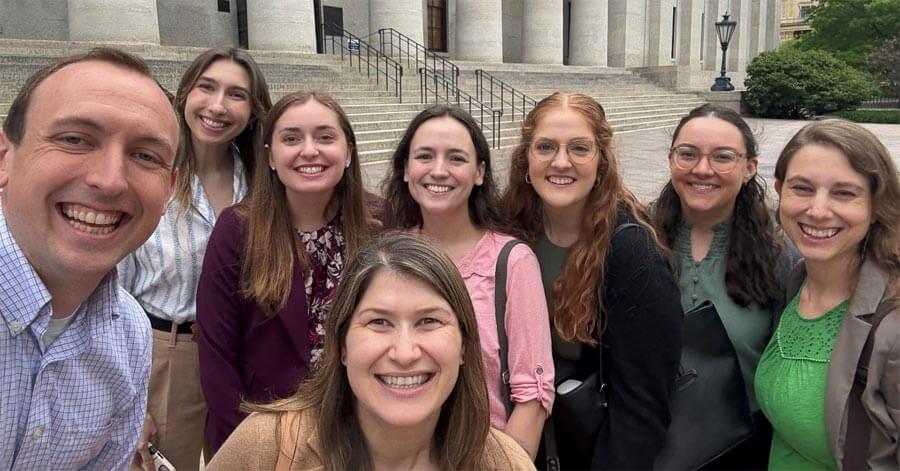 group of residents laughing in front of stairs