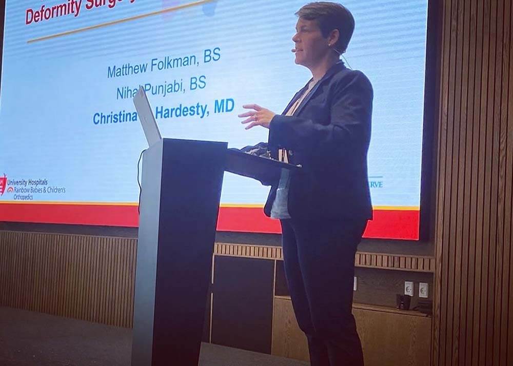 physician at podium at a conference