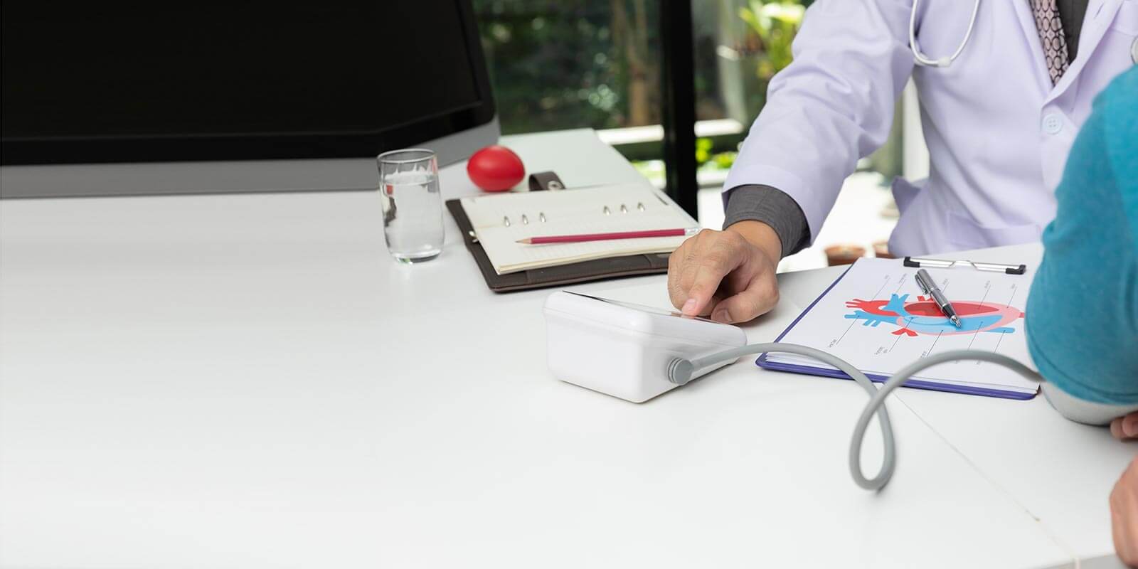 physician with blood pressure monitor