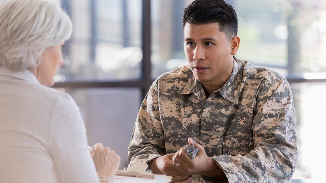 physician talking with a soldier