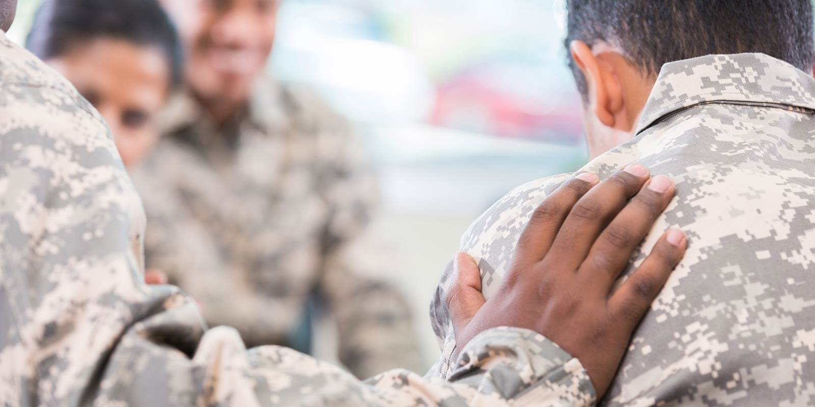 Soldier comforts friend during support group meeting