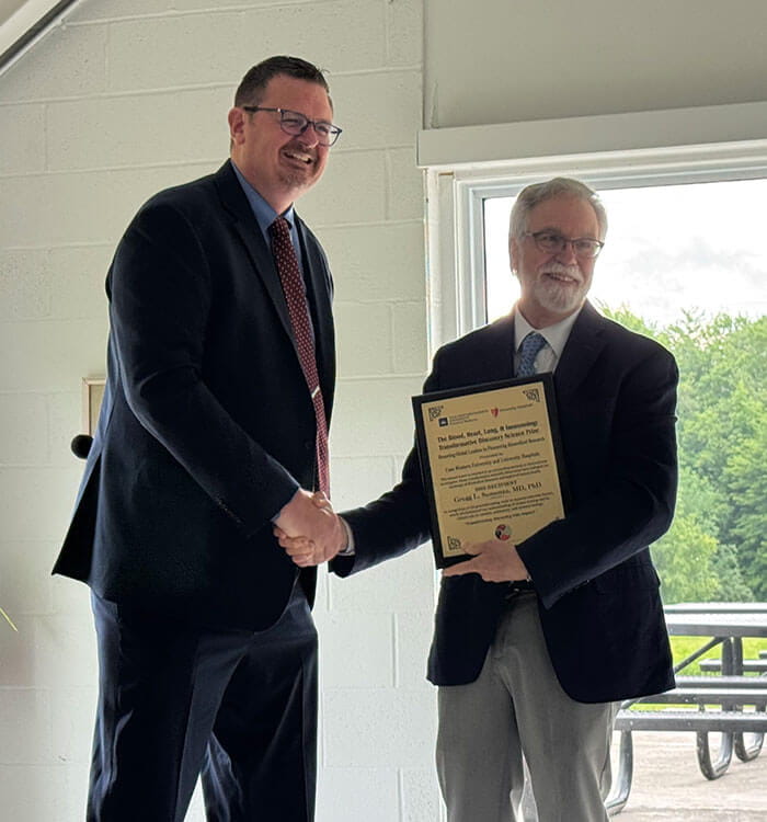 Kenneth Remy, MD presents the inaugural Robert Salata Prize for Academic Excellence in Research to Dr. Semenza.