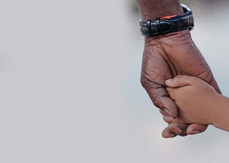 Father and son holding hands.