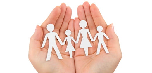 Hands holding people cutouts.