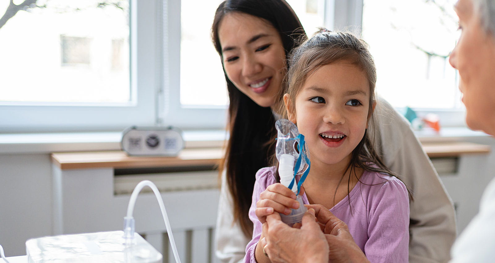 A girl receives treatment with a nebulizer