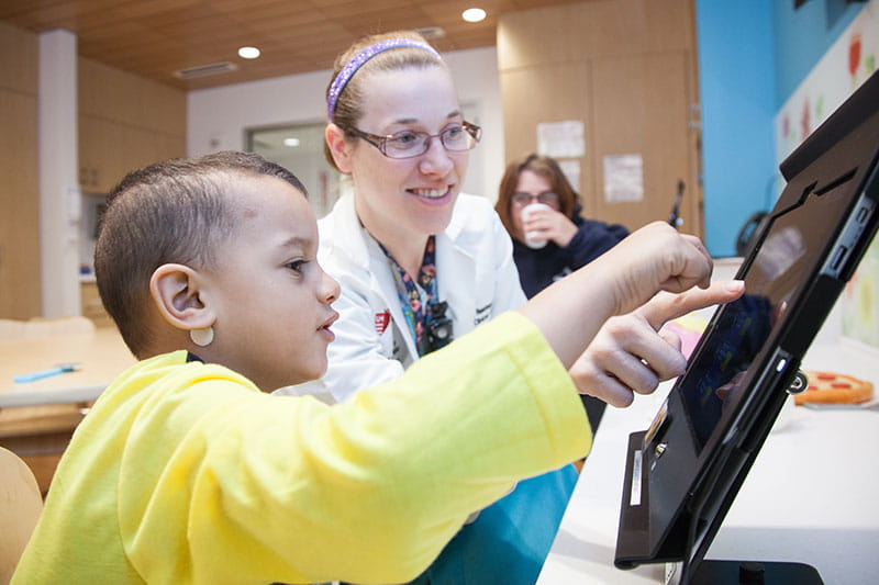 Rainbow Babies & Children’s Hospital lab nurse working with boy