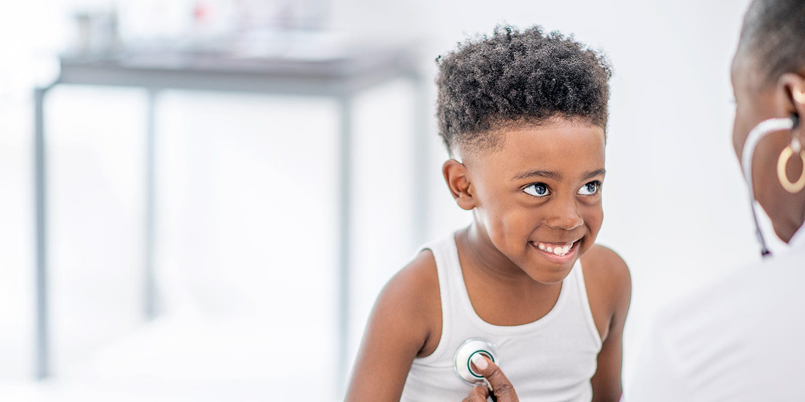 A young boy being given an examination with a stethoscope