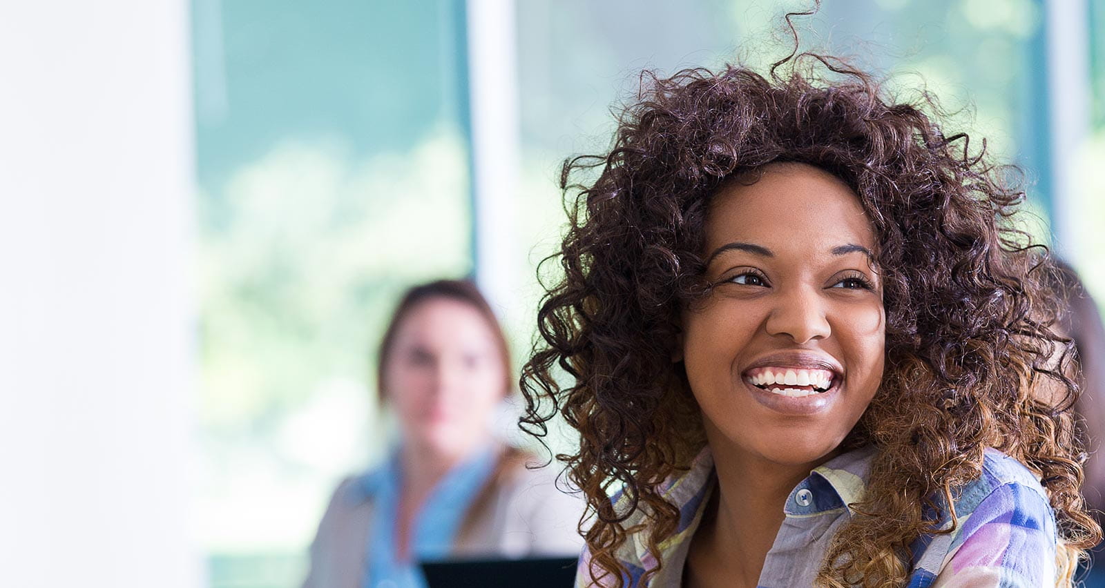 Young woman laughing in a classroom