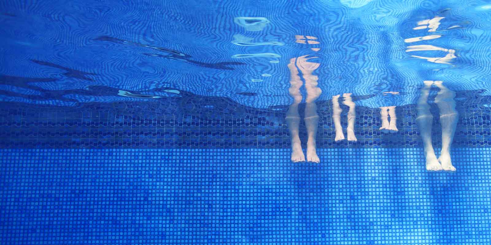 Underwater image in a swimming pool with legs dipped in