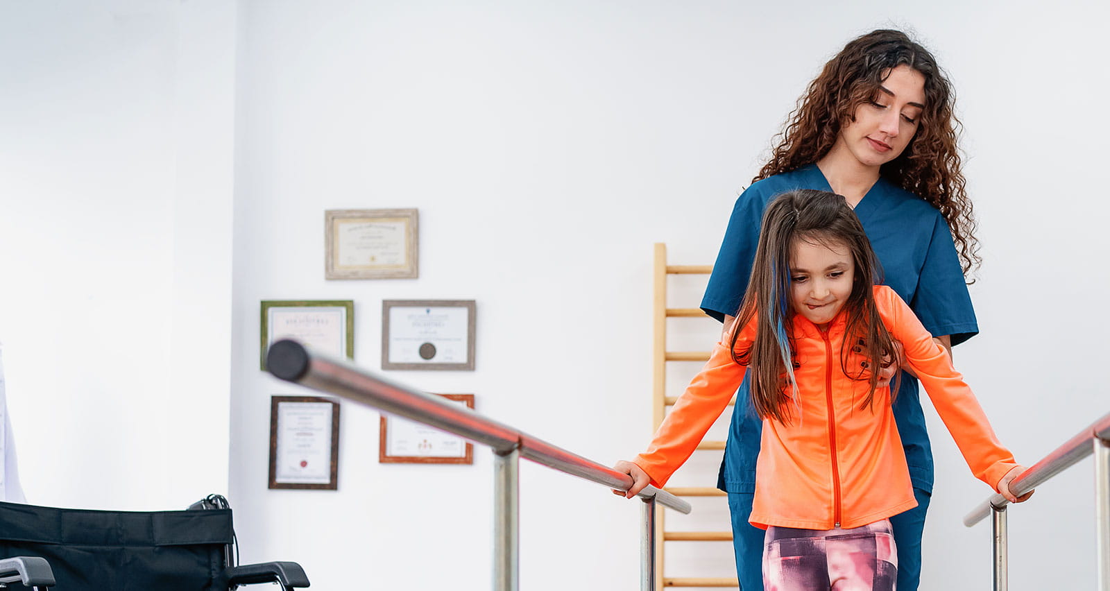A young patient doing physiotherapy at a clinic with help of a therapist after suffering an injury