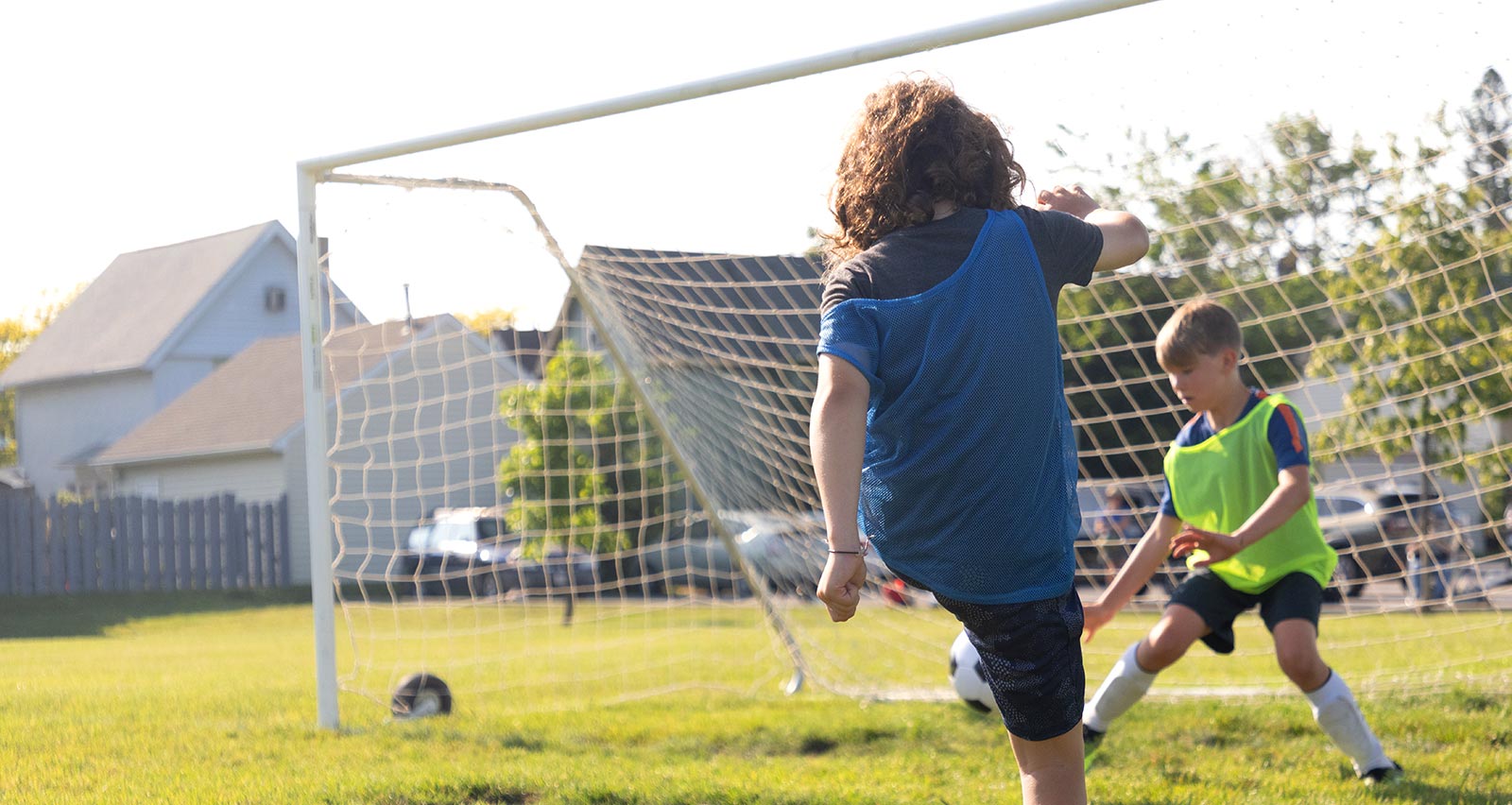 A young soccer player takes a kick