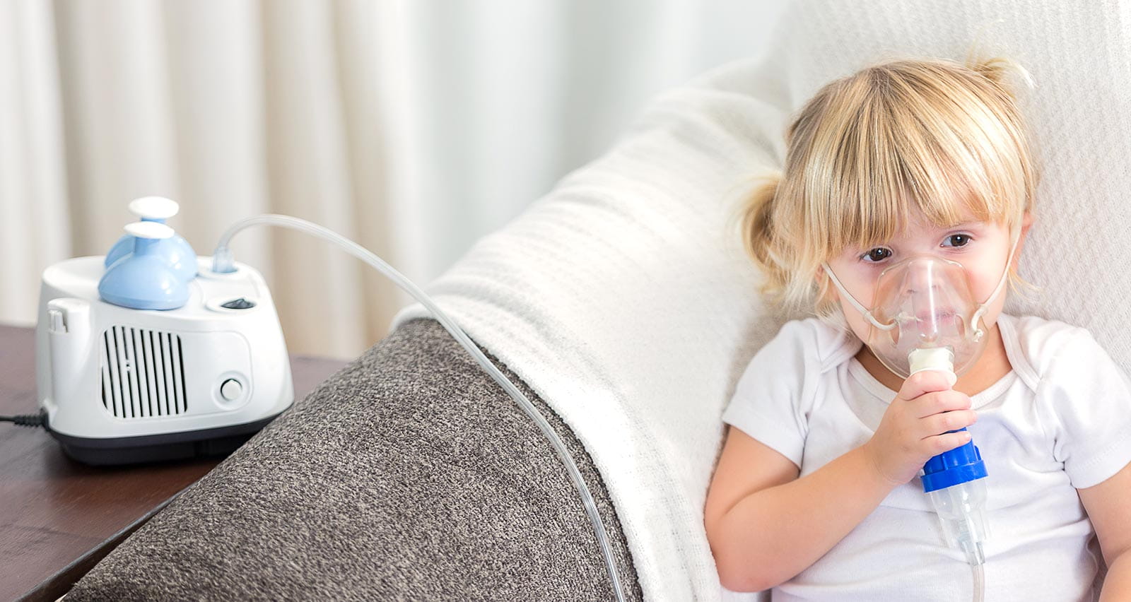A preschool age girl with cystic fibrosis receives breathing treatment