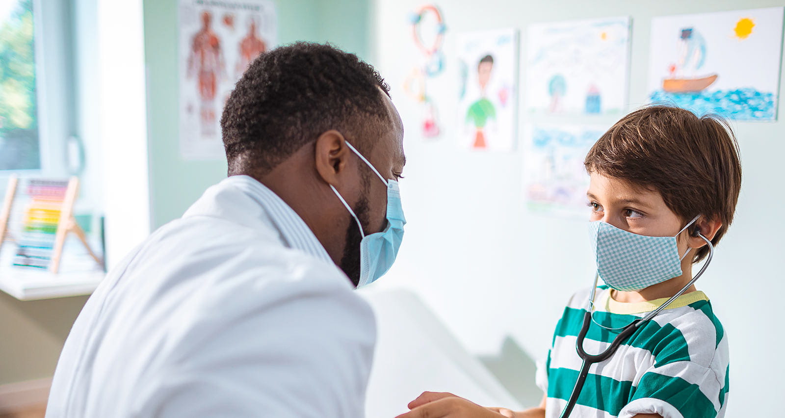 Close up of a pediatrician having a check up on his young patient
