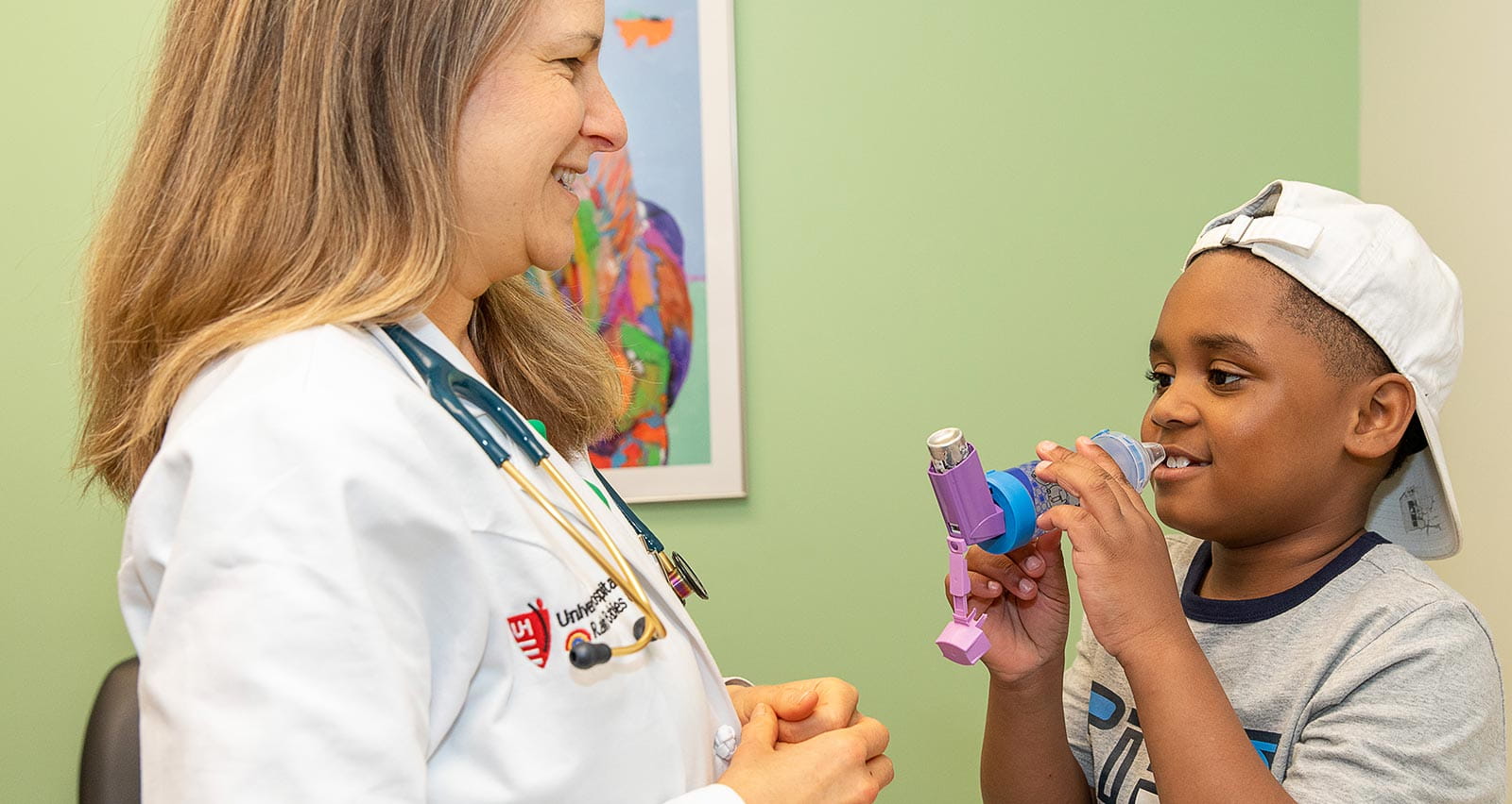 A young patient uses an inhaler