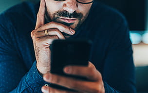 Young man addicted to social media texting in the dusk at home
