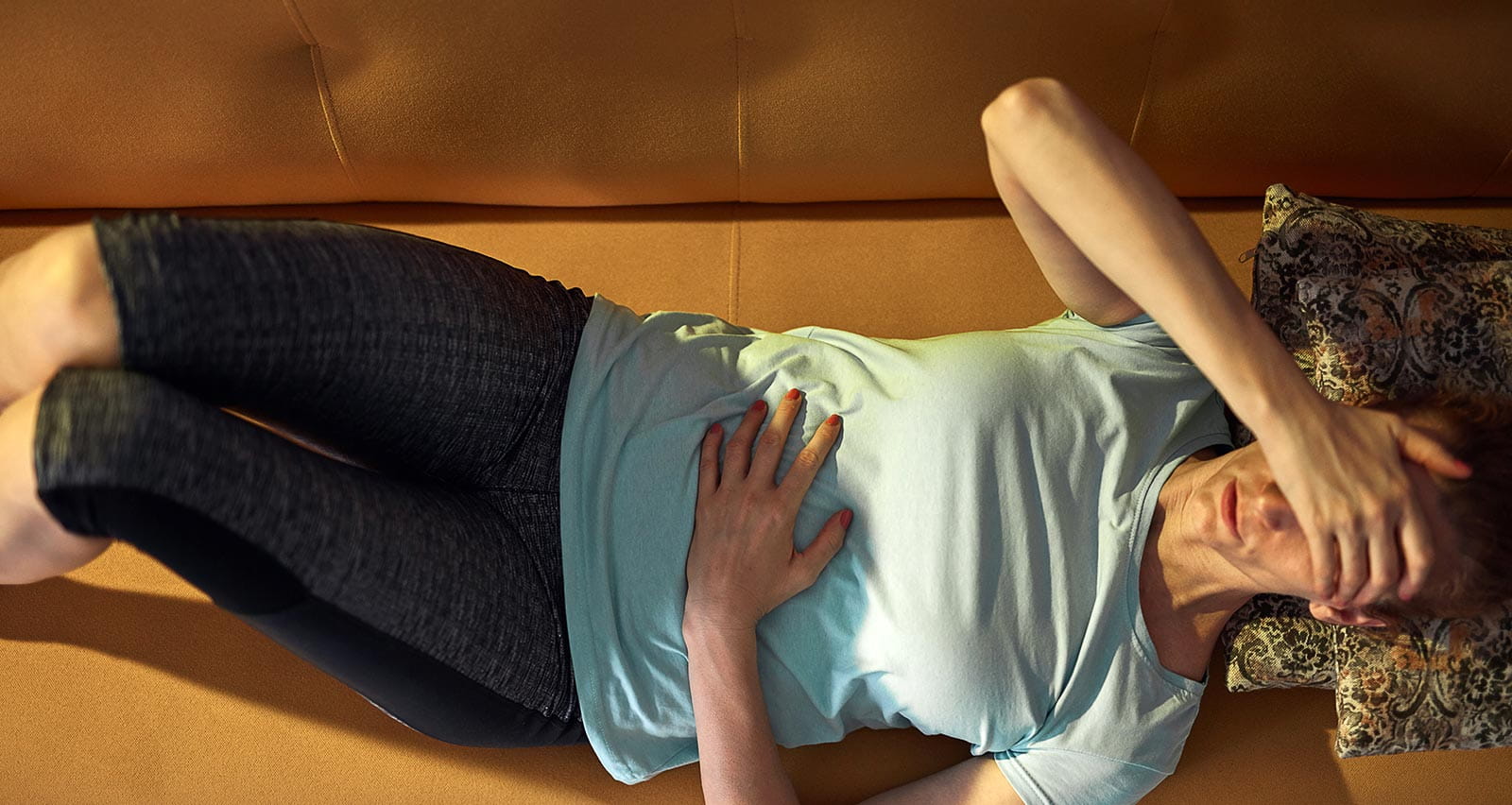 Woman with strong stomach pain clutching midsection