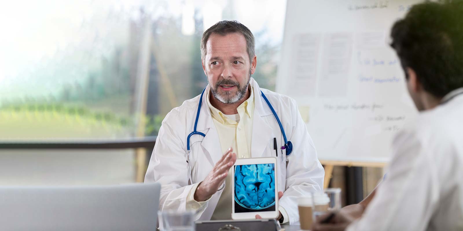 Doctors talking about Pink Tumors with tablet