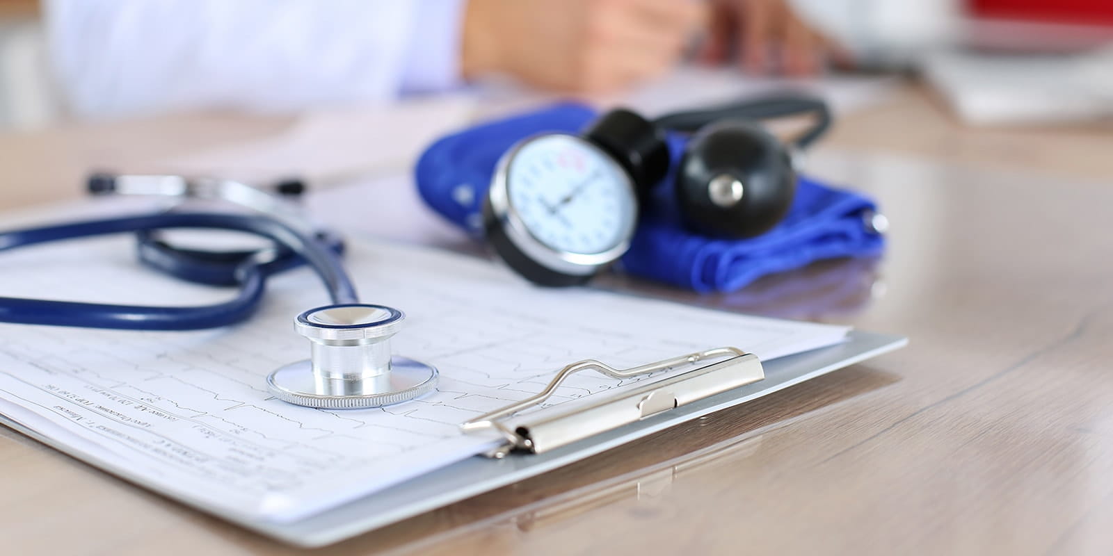 Medical stethoscope lying on cardiogram chart
