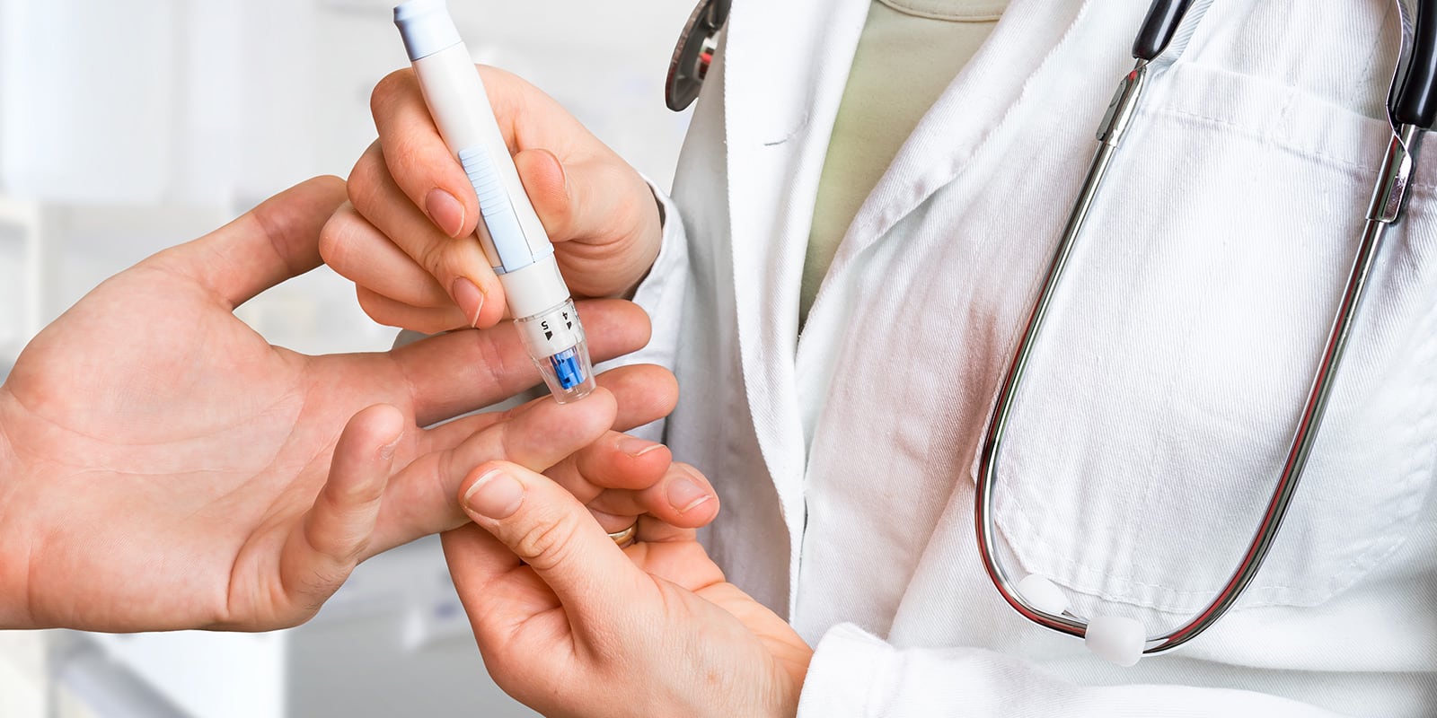 Doctor taking blood from patient using pen stick.