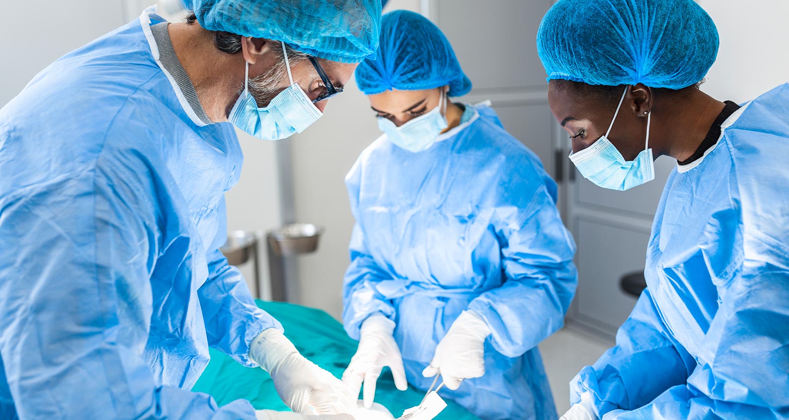 Performing surgery in hospital operating theater