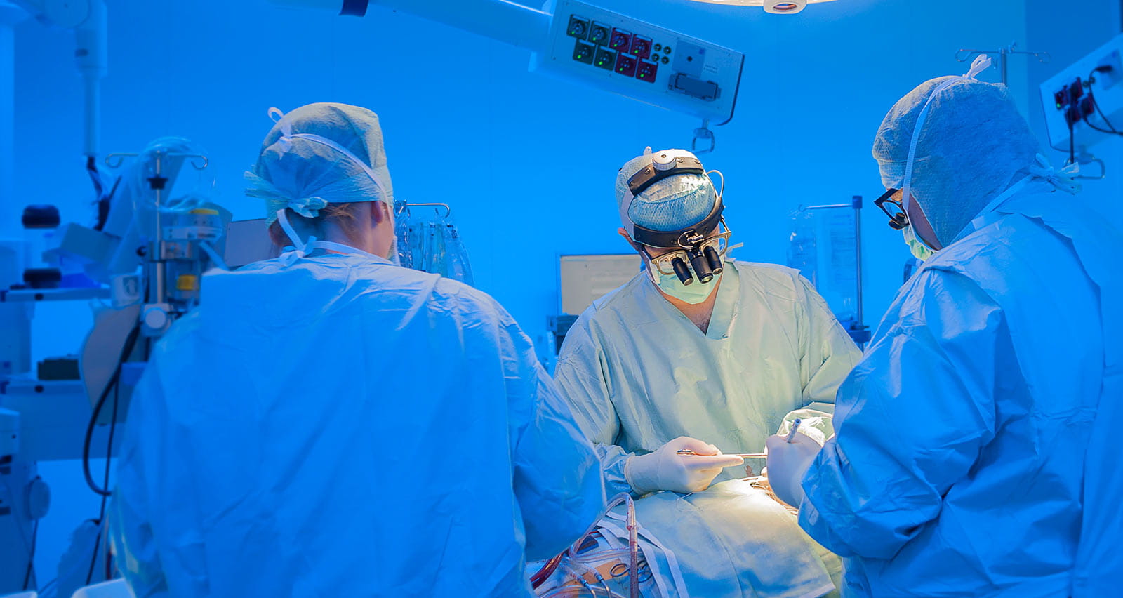 Surgeons performing open heart surgery in modern operation room