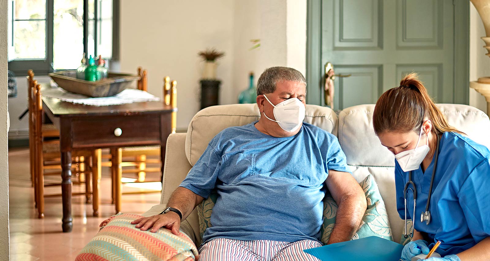 Nurse making in-home call to care for older man in recovery