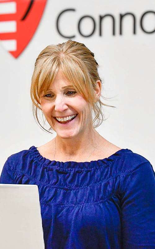 Whole Health & Well-Being Coach Coordinator Crystal Evans uses a laptop at UH Connor Whole Health
