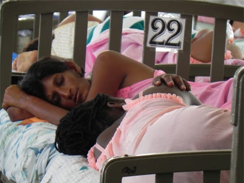 Two patients sleep in bed