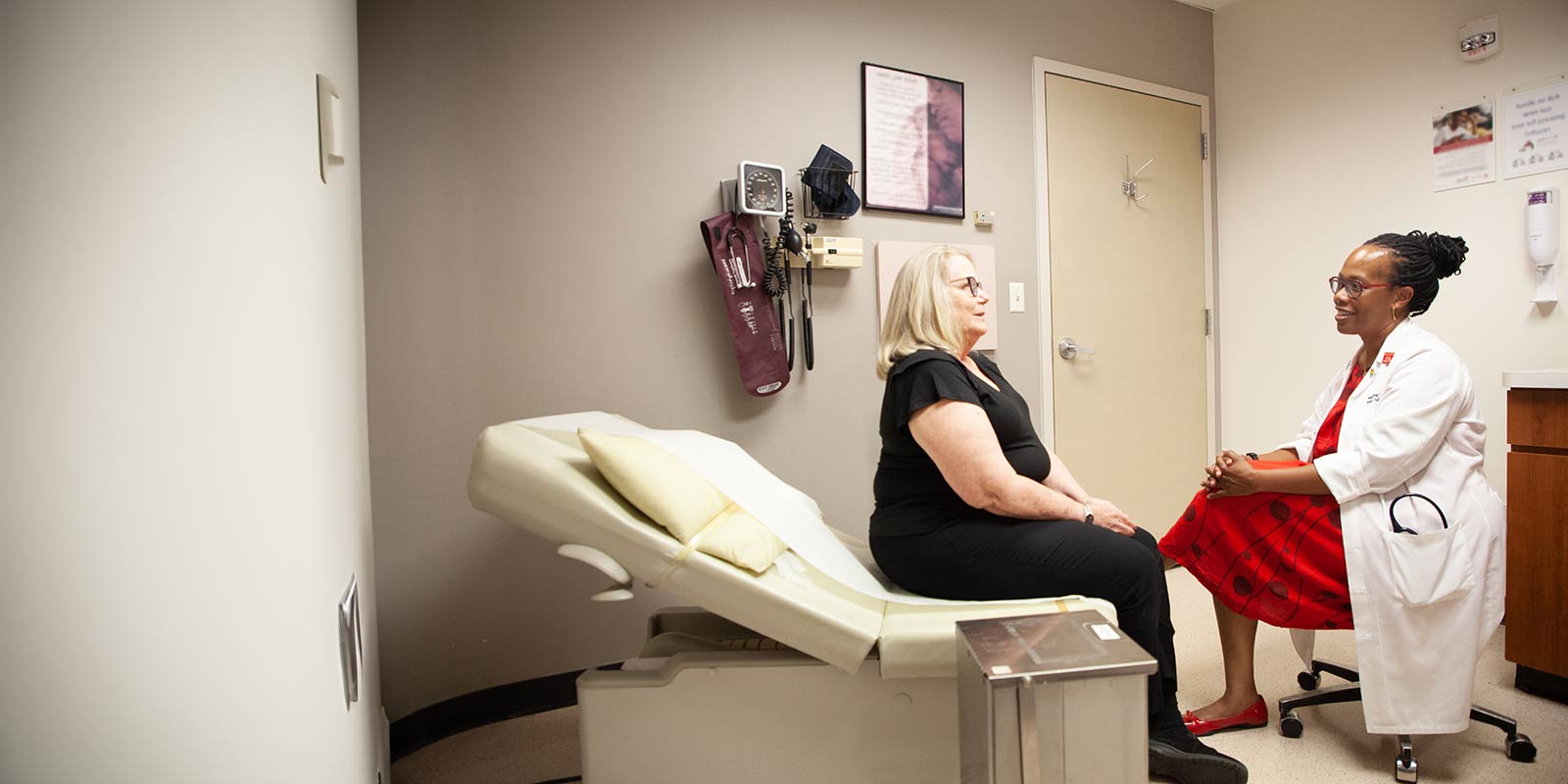 Dr. Tia Melton talking with female patient in office