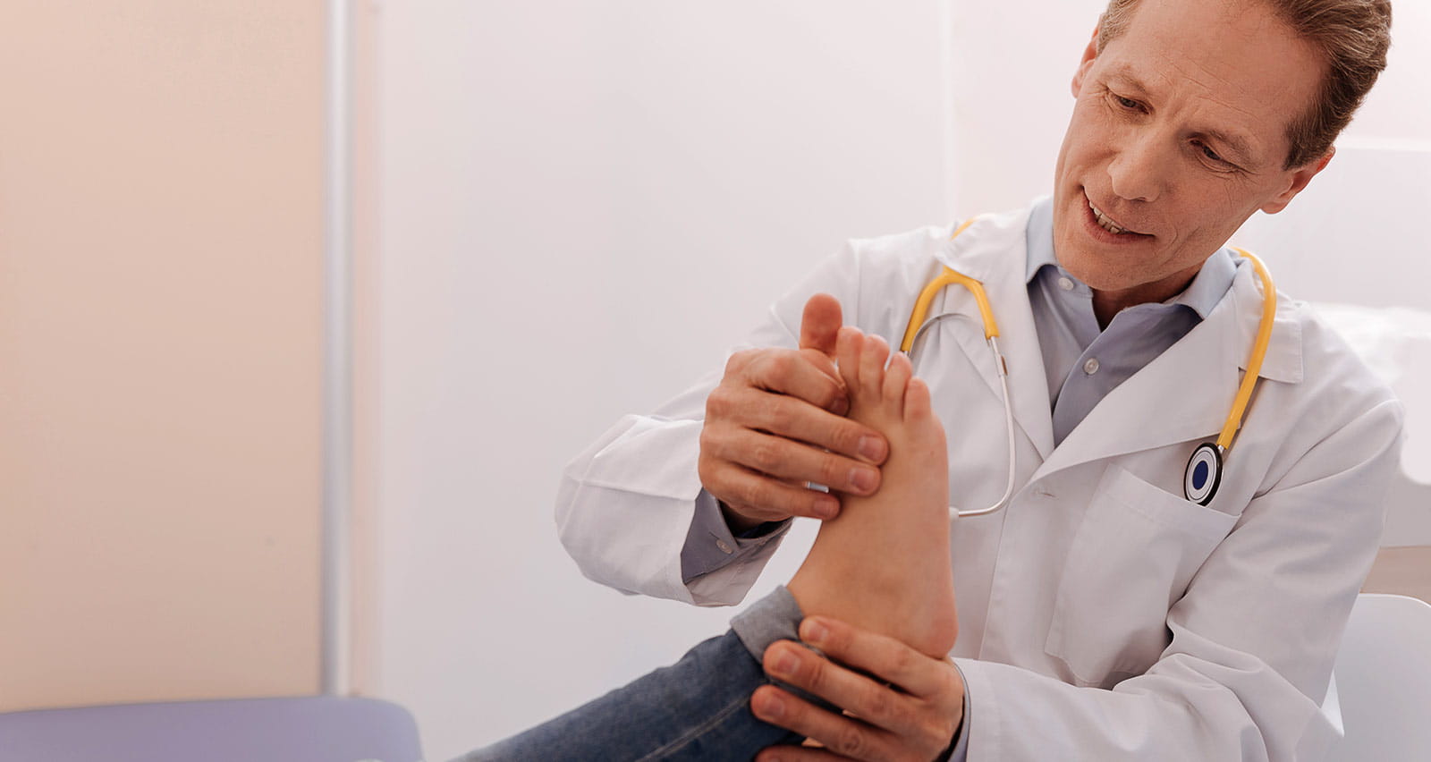 A medical professional examining a woman’s foot, looking for any signs of disease