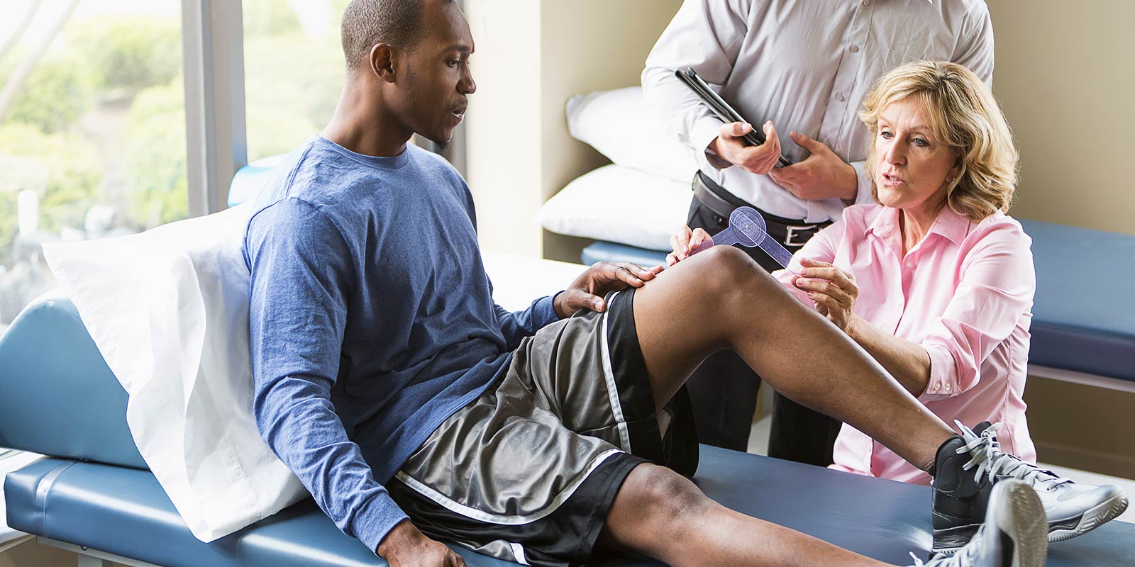 Physical therapists examining patient