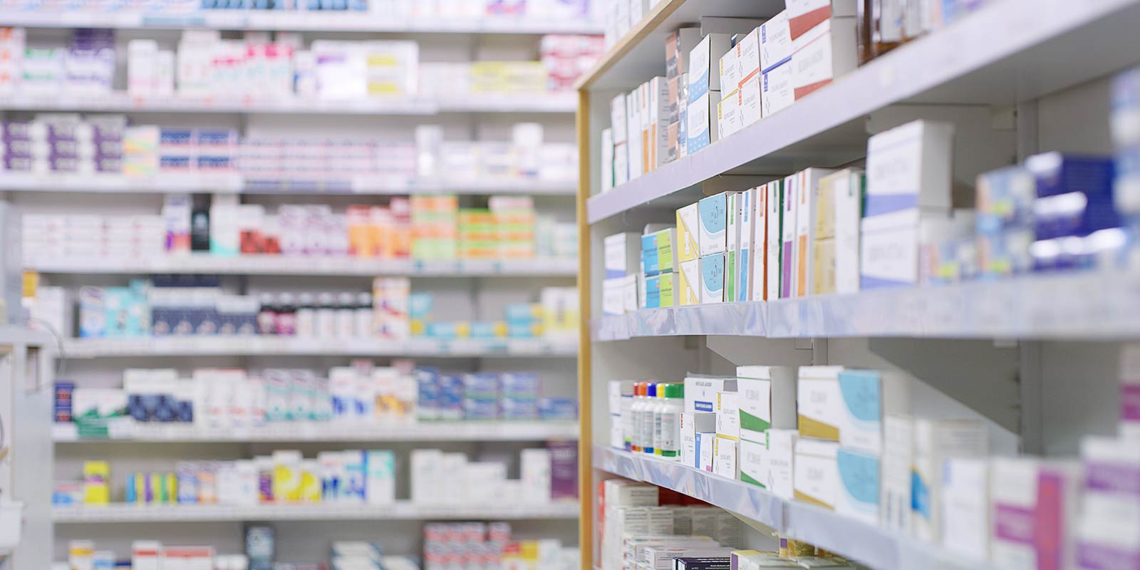 Pharmacy shelves stocked with various medicinal products