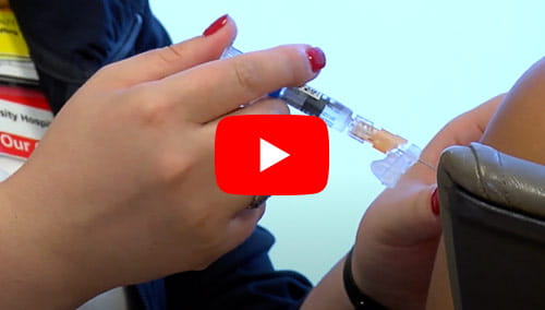 A patient is being immunized by a UH Roe Green Center for Travel Medicine provider